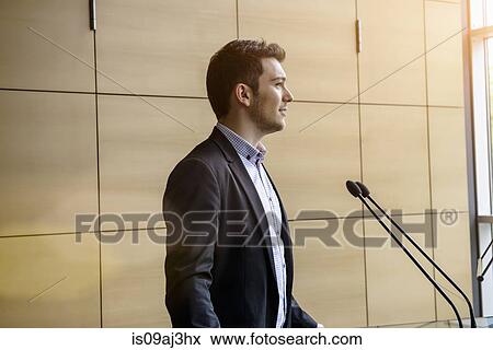 Young businessman speaking in conference View Large Photo Image Stock Photo - Young businessman speaking in conference. Fotosearch