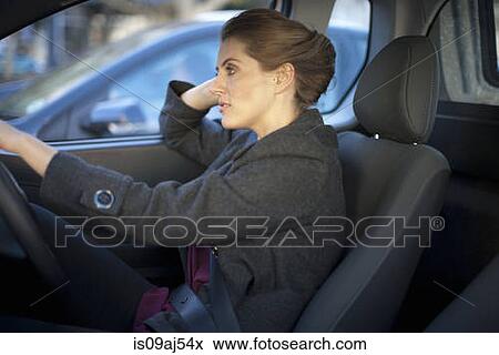 Young businesswoman driving in traffic congestion View Large Photo Image Stock Photo - Young businesswoman driving in traffic congestion. Fotosearch
