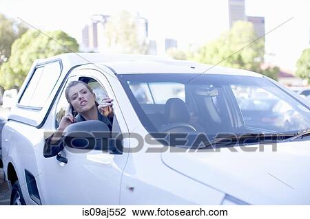 Young businesswoman shouting from car window in city View Large Photo Image Stock Image - Young businesswoman shouting from car window in city. Fotosearch
