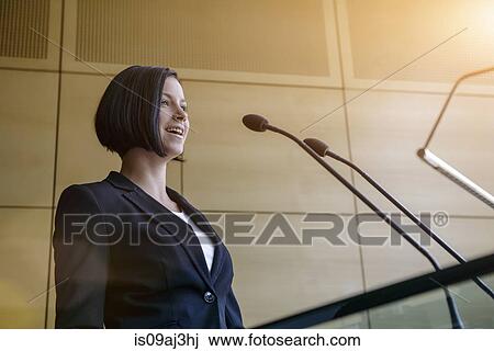 Young businesswoman speaking in conference room View Large Photo Image Stock Image - Young businesswoman speaking in conference room. Fotosearch