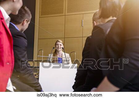 Young businesswoman speaking to audience in conference room View Large Photo Image Stock Photography - Young businesswoman speaking to audience in conference room. Fotosearch