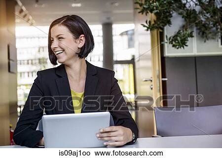 Young businesswoman with digital tablet in office View Large Photo Image Picture - Young businesswoman with digital tablet in office. Fotosearch