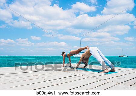 Young couple in double yoga pose on pier, San Pedro, Belize View Large Photo Image Stock Image - Young couple in double yoga pose on pier, San Pedro, Belize. Fotosearch