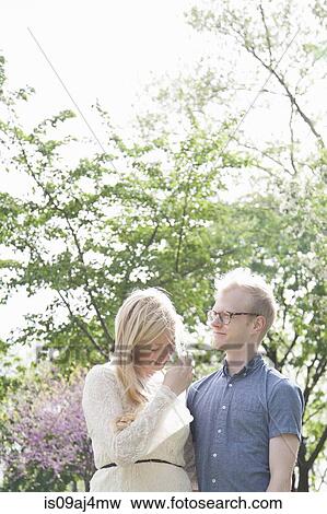 Young couple in park View Large Photo Image Stock Photo - Young couple in park. Fotosearch