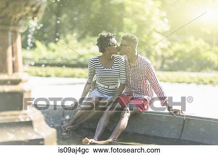 Young couple kissing with bare feet in Bethesda fountain, Central Park, New York City, USA View Large Photo Image Stock Image - Young couple kissing with bare feet in Bethesda fountain, Central Park, New York City, USA. Fotosearch