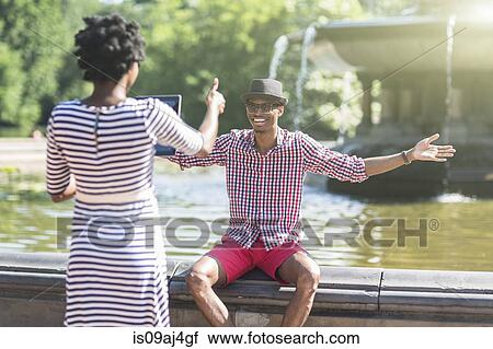 Young couple photographing with digital tablet, Bethesda fountain, Central Park, New York City, USA View Large Photo Image Stock Image - Young couple photographing with digital tablet, Bethesda fountain, Central Park, New York City, USA. Fotosearch