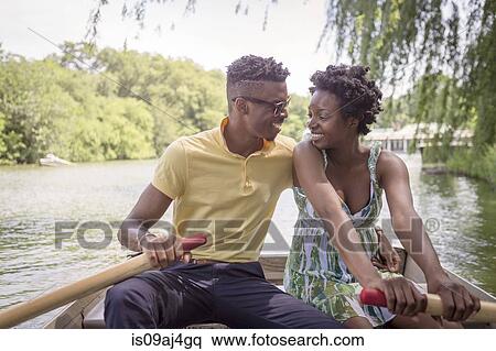 Young couple rowing on lake in Central Park, New York City, USA View Large Photo Image Stock Photography - Young couple rowing on lake in Central Park, New York City, USA. Fotosearch
