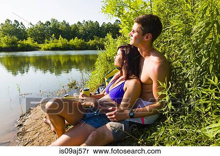 Stock Photography - Young couple sitting on canal bank, Delaware Canal State Park, New Hope, Pennsylvania, USA. Fotosearch