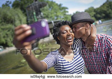 Young couple taking selfie with smartphone, Bethesda fountain, Central Park, New York City, USA View Large Photo Image Stock Image - Young couple taking selfie with smartphone, Bethesda fountain, Central Park, New York City, USA. Fotosearch
