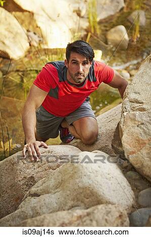 Young male free climber, climbing up rocks View Large Photo Image Stock Photograph - Young male free climber, climbing up rocks. Fotosearch