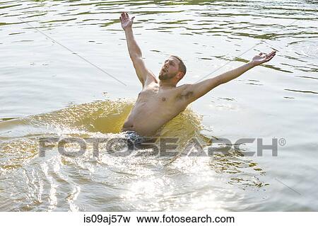 Young man falling backwards into river View Large Photo Image Stock Photo - Young man falling backwards into river. Fotosearch