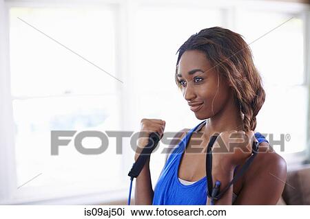 Young woman exercising in sitting room View Large Photo Image Stock Image - Young woman exercising in sitting room. Fotosearch