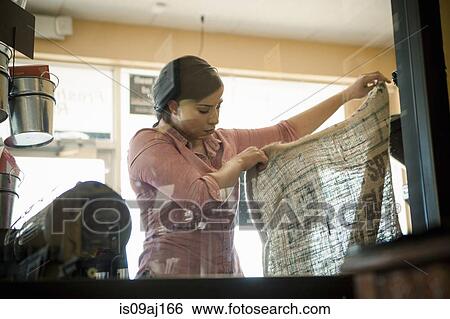 Young woman holding up empty sack used for coffee roasting machine in cafe View Large Photo Image Stock Photograph - Young woman holding up empty sack used for coffee roasting machine in cafe. Fotosearch