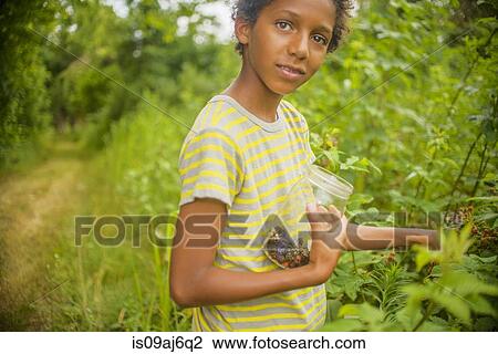 Boy picking berries View Large Photo Image Stock Image - Boy picking berries. Fotosearch