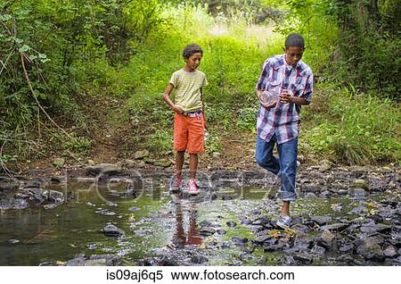 Boys catching fish with jar View Large Photo Image Stock Photography - Boys catching fish with jar. Fotosearch