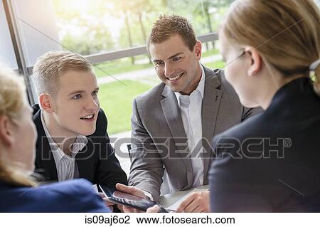 Stock Image - Business colleagues meeting to share ideas. Fotosearch