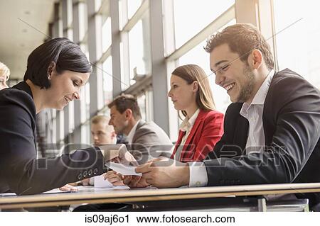 Stock Image - Business colleagues sharing ideas at meeting. Fotosearch