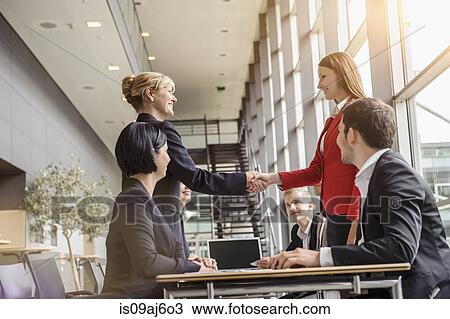 Businesswoman and team meeting client View Large Photo Image Stock Image - Businesswoman and team meeting client. Fotosearch