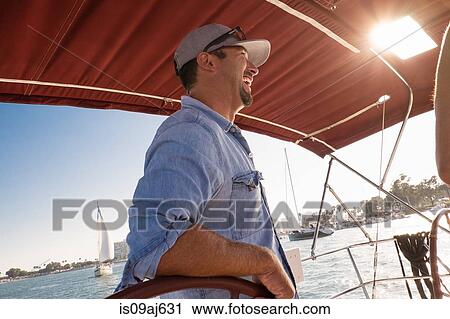 Captain on yacht, smiling View Large Photo Image Stock Image - Captain on yacht, smiling. Fotosearch
