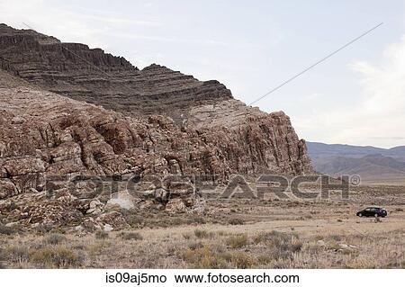 Picture - Car parked near rock formation, Ibex, Utah, USA. Fotosearch
