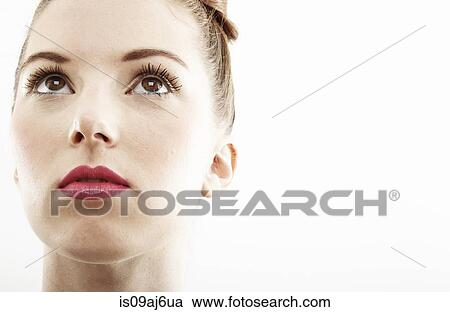 Stock Image - Close up studio portrait of beautiful young woman. Fotosearch