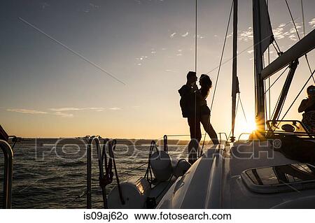 Couple on yacht, silhouette View Large Photo Image Picture - Couple on yacht, silhouette. Fotosearch