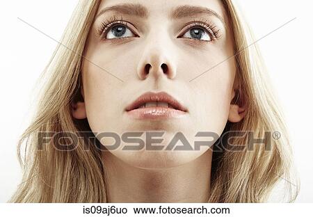 Picture - Cropped close up studio portrait of young woman gazing upward. Fotosearch