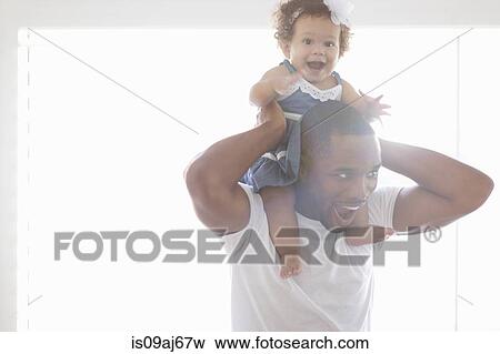 Stock Photo - Father holding baby daughter on his shoulders. Fotosearch