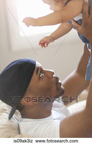 Father lifting young daughter in the air View Large Photo Image Stock Photo - Father lifting young daughter in the air. Fotosearch