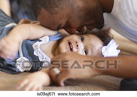 Father playing with baby daughter View Large Photo Image Stock Photograph - Father playing with baby daughter. Fotosearch