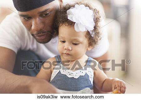Stock Photo - Father playing with young daughter. Fotosearch