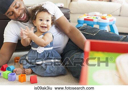 Stock Photograph - Father playing with young daughter. Fotosearch