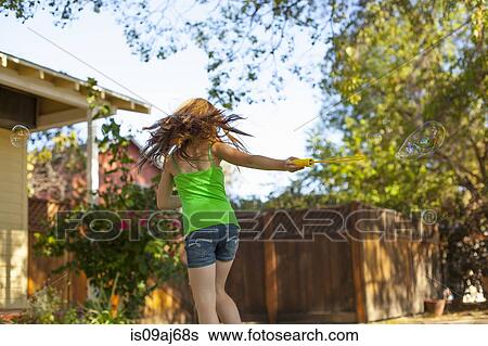 Stock Photograph - Girl running in garden. Fotosearch
