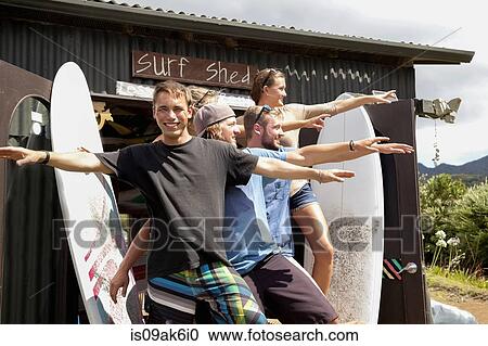 Group portrait of five young adult surfer friends posing with arms outstretched View Large Photo Image Stock Image - Group portrait of five young adult surfer friends posing with arms outstretched. Fotosearch