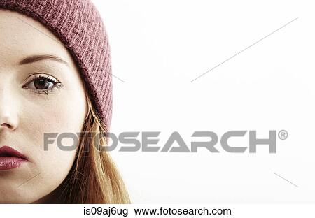 Stock Image - Half face close up studio portrait of young woman. Fotosearch