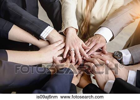 Hands of group of businesswomen and men together in a circle View Large Photo Image Picture - Hands of group of businesswomen and men together in a circle. Fotosearch