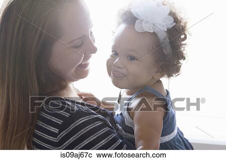 Mother holding baby daughter View Large Photo Image Stock Image - Mother holding baby daughter. Fotosearch