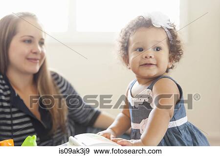 Mother watching young daughter play View Large Photo Image Stock Photo - Mother watching young daughter play. Fotosearch