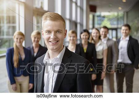 Portrait of businessman and business team standing in a row View Large Photo Image Stock Photo - Portrait of businessman and business team standing in a row. Fotosearch
