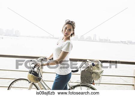 Portrait of mid adult female cyclist at riverside, New York City, USA View Large Photo Image Stock Image - Portrait of mid adult female cyclist at riverside, New York City, USA. Fotosearch