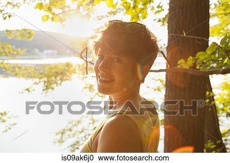 Portrait of mid adult woman by lakeside at sunset View Large Photo Image Stock Image - Portrait of mid adult woman by lakeside at sunset. Fotosearch