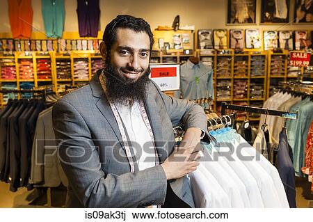Portrait of tailor leaning against rails in men's clothes shop View Large Photo Image Stock Image - Portrait of tailor leaning against rails in men's clothes shop. Fotosearch