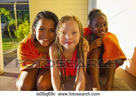 Portrait of three girls wrapped in towel on porch View Large Photo Image Stock Image - Portrait of three girls wrapped in towel on porch. Fotosearch