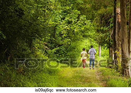 Rear view of boys walking in forest View Large Photo Image Stock Image - Rear view of boys walking in forest. Fotosearch