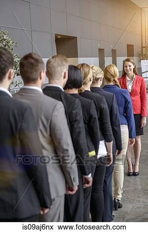 Rear view of businesswoman and business team standing in a row View Large Photo Image Stock Photo - Rear view of businesswoman and business team standing in a row. Fotosearch