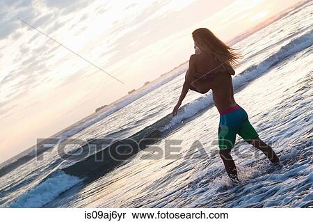 Romantic young man carrying girlfriend in arms on beach, Nosara, Guanacaste, Costa Rica View Large Photo Image Stock Photography - Romantic young man carrying girlfriend in arms on beach, Nosara, Guanacaste, Costa Rica. Fotosearch