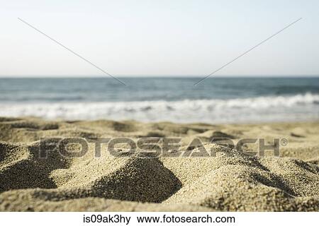 Stock Photo - Sand dunes and sea, focus on sand. Fotosearch