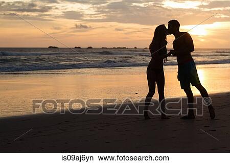Silhouette of romantic couple kissing on beach, Nosara, Guanacaste, Costa Rica View Large Photo Image Picture - Silhouette of romantic couple kissing on beach, Nosara, Guanacaste, Costa Rica. Fotosearch