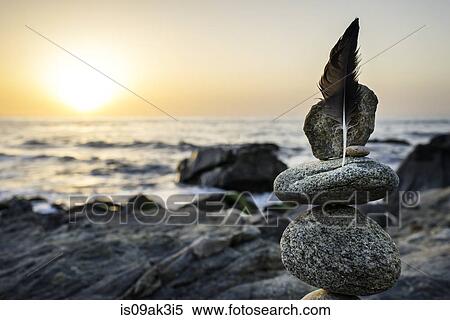 Still life of rocks and feather on beach View Large Photo Image Stock Photography - Still life of rocks and feather on beach. Fotosearch