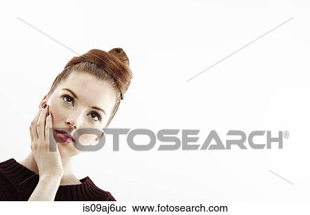 Studio portrait of beautiful young woman with hand on face View Large Photo Image Stock Image - Studio portrait of beautiful young woman with hand on face. Fotosearch